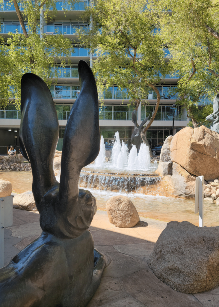 Large rabbit sculptures ("Three Blacktail Rabbits" by Mark Rossi next to Pedal Haus Brewery