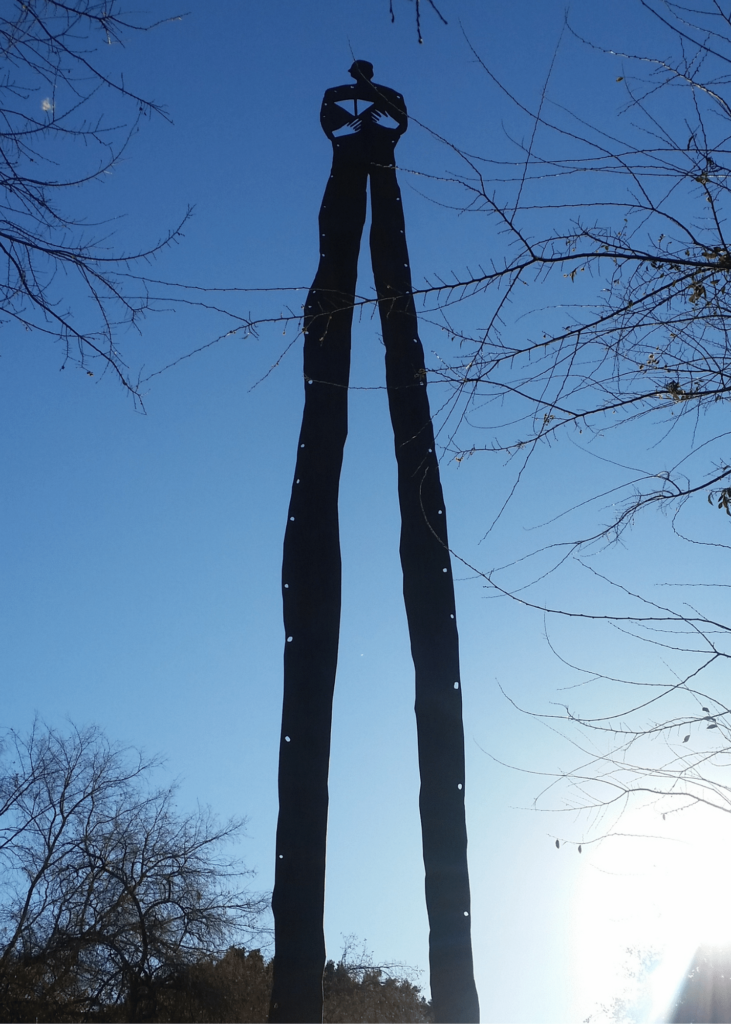 Sculpture of a tall man in Tempe called Above the Crowd by John Nelson